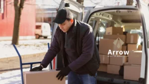 A delivery worker unloading boxes from a van in a snowy area, representing Arrow Dispatch Services’ efficient freight and last-mile delivery.